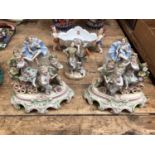 Six pieces of continental porcelain, including a pair of figures on stone bases, a pair of figural g
