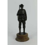 Contemporary bronzed resin figure of a First World War Tommy, mounted on circular wooden base, 24cm