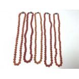 Five Chinese carnelian polished bead necklaces