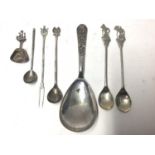 Collection of silver and white metal items to include Russian silver spoon, Dutch silver caddy spoon