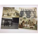 Postcards in large album including real photographic animated street scenes and shop fronts