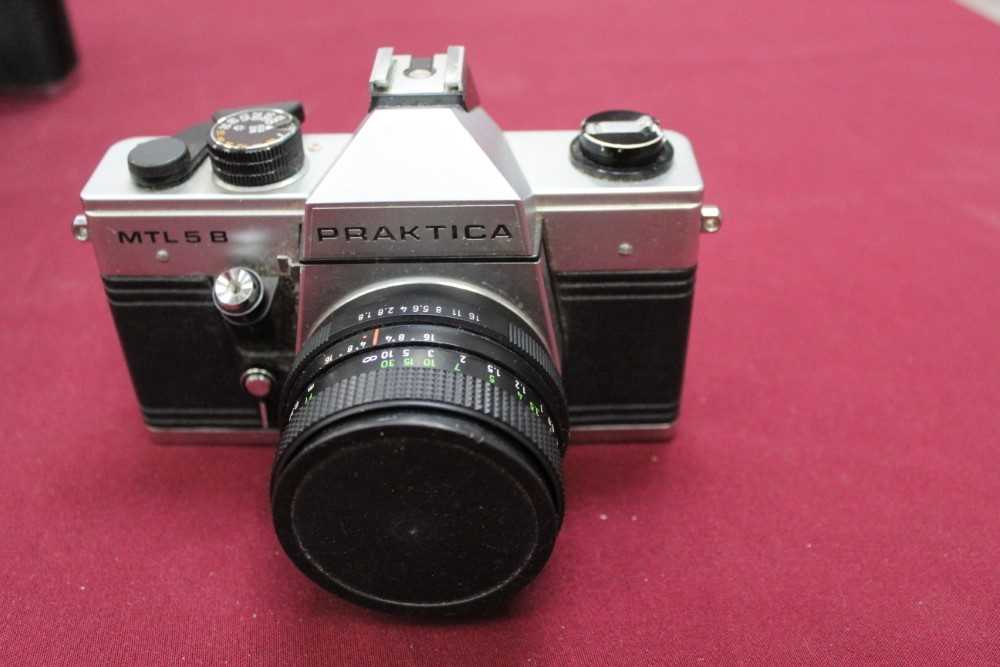 Group of cameras and lenses, including several Praktica, Kodak Retinas, Bolex cine camera, etc