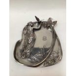 WMF Art Nouveau style dish, relief decorated with a woman holding a bird, marks to base, 32cm high