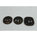 Japanese bronze tsuba with figural decoration, together with two other bronze tsuba's (3)