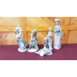 Five Lladro porcelain figures including clown and girl with balloons