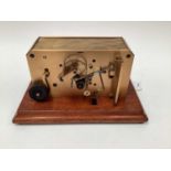 Rare early 20th century brass ticker tape machine on mahogany base