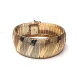 Three colour gold (stamped 750) articulated cuff bracelet