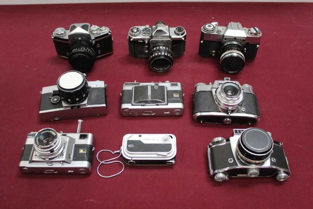 Group of cameras and lenses, including Edixa, Exakta, Zeiss, Voigtlander, etc, in two hard cases