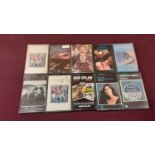 Box of music cassettes including Bob Dylan, Eric Clapton, Paul Simon, Dire Straits, Simon & Garfunke