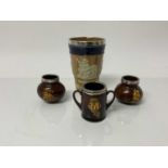 Doulton Lambeth stoneware beaker with silver rim, together with three Royal Doulton Dickens items -