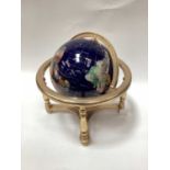 Contemporary table globe with semi precious hard stone inlaid decoration.