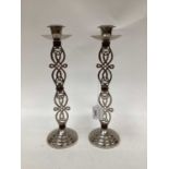 Pair of white metal candlesticks set with amber