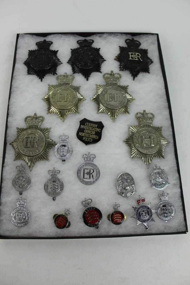 Three cases of Elizabeth II Police helmet plates and other badges to include Warwickshire, Dorset an
