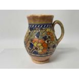 Charlotte Rhead Crown Ducal jug with orange and blue floral decoration, signed, 25.5cm high