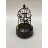 A singing birdcage automaton, 20th century, brass-cased, with a dome top, the yellow and blue singin