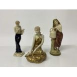 Three Royal Dux figures - lady in gold dress, lady with large pot and semi clad lady, all with pink