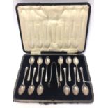 Set of twelve George V silver tea spoons, together with matching sugar tongs, (mostly assayed Sheffi