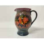 Moorcroft pottery Flambe jug decorated in the leaf and berry pattern, impressed marks and blue paint