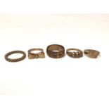 Three 9ct gold rings, yellow metal twisted band ring and one other (5)