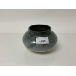 Rookwood pottery squat vase decorated with leaves and berries on grey/blue ground, impressed marks t