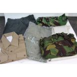 Four boxes of military clothing and uniform to include jackets, Police helmets, hats etc