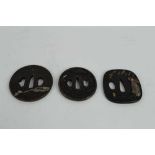 Japanese bronze tsuba with decoration depicting Carp, together with two other bronze tsuba's (3)