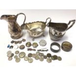 Silver sauce boat, Arts & Crafts white metal milk jug, two silver cased watches, silver mounted coin