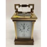 Large brass cased carriage clock and key with Corinthian column decoration, the dial signed 'Saint S