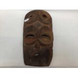Large African wooden mask with four eyes, traces of polychrome, together with a smaller female Afric