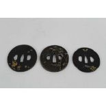 Japanese bronze tsuba with decoration depicting Storks, together with two other bronze tsuba's (3)
