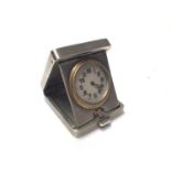 George V Art Deco silver travelling time piece, mounted in a folding easel stand case with engine tu