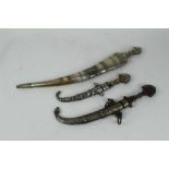 Arab Jambiya dagger with silver and brass mounted scabbard and grip, together with two other Eastern