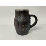 Doulton Slaters Patent stoneware jug in the form of a leather blackjack, with silver rim, impressed
