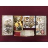 A box of antique and vintage dress clips including paste, glass, filigree metal work, enamel, bakeli