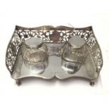Edwardian silver ink stand of rectangular form with pierced decoration, and two silver topped glass