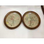 Pair of antique silk embroidered panels in oval frames