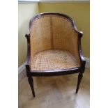 Edwardian neoclassical revival carved mahogany bergere tub chair with rams head terminals, carved hu