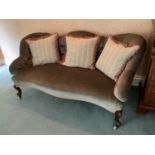 Victorian button upholstered serpentine settee, raised on cabriole legs and castors