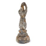 Antique composition garden finial, in the form of a forearm, holding a ball, 41cm high