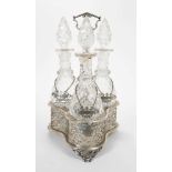 Victorian silver decanter stand containing three cut glass decanters with silver labels