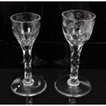 Two Georgian wine glasses with floral and swag cut bowls on faceted stems on splayed foot 13.5-14 cm