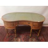 Good quality Edwardian satinwood kidney shape writing table with. Tooled leather inset top, central