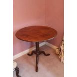 George III mahogany tripod table with tilt top on birdcage mechanism, cannon barrel column and three