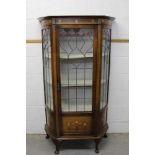 Art Nouveau glazed display cabinet with stained glass.