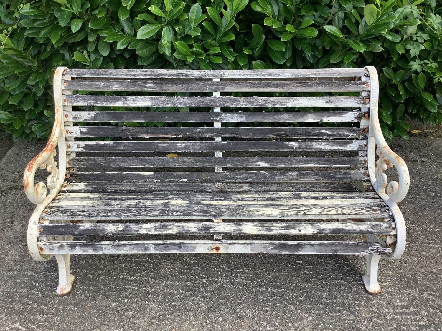 Victorian style cast iron garden bench with wooden slats