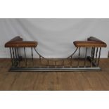 Good antique style steel and brass club fender with brown leather studded seats, on spiral and sqaur