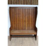 Oak high back settle in the antique style