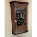 George III mahogany and boxwood line inlaid corner cupboard, enclosed by an astragal glazed door, 68