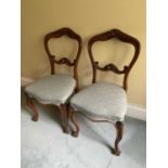 Set of six mid Victorian carved walnut dining chairs, each with arched carved back on cabriole legs