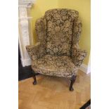 Good George I walnut wing back armchair with scroll arms on carved cabriole front supports with carv